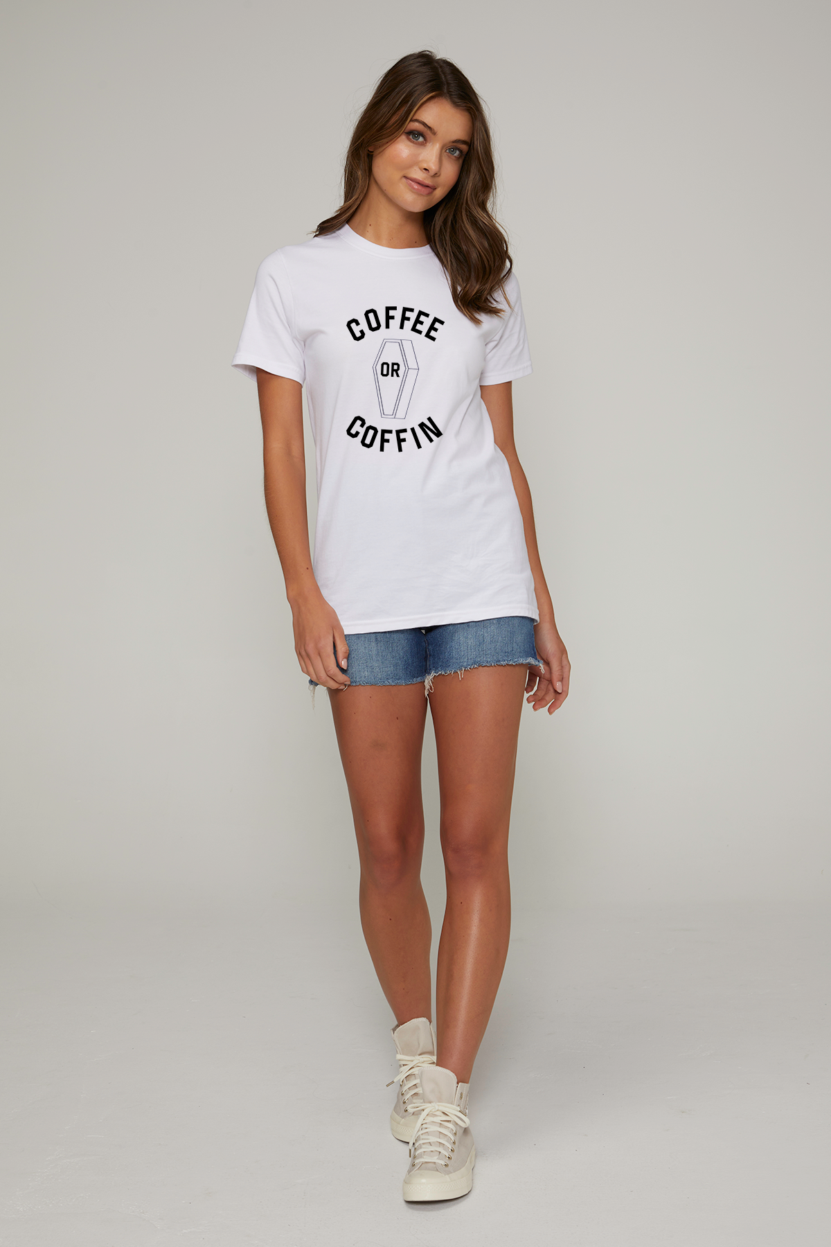 A woman wearing a white t-shirt with the black text &