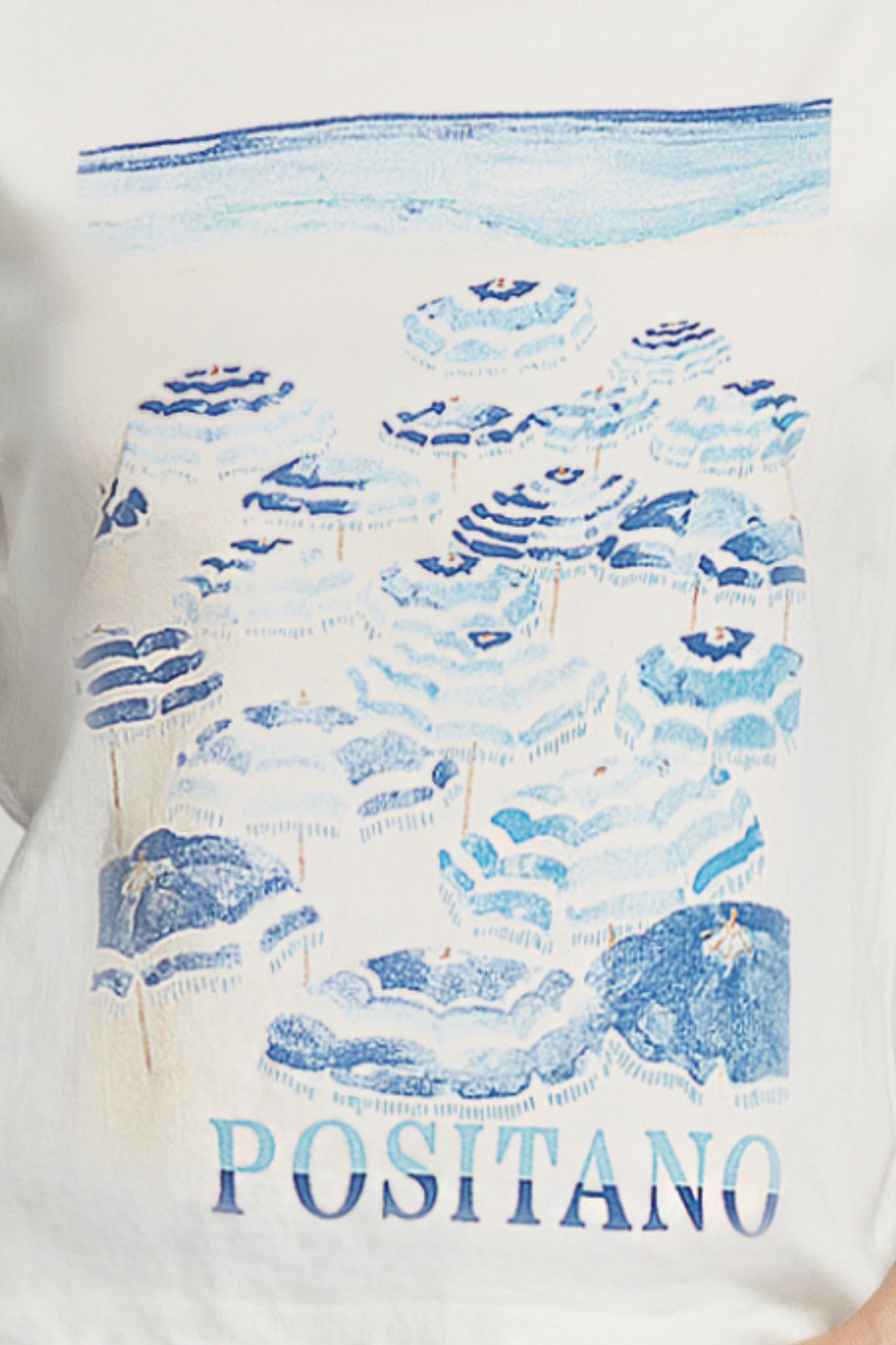 Close up of white shirt with blue striped umbrellas on the beach pattern and &