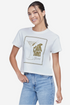 A woman wearing a white crop top with a martini glass graphic and text that includes &