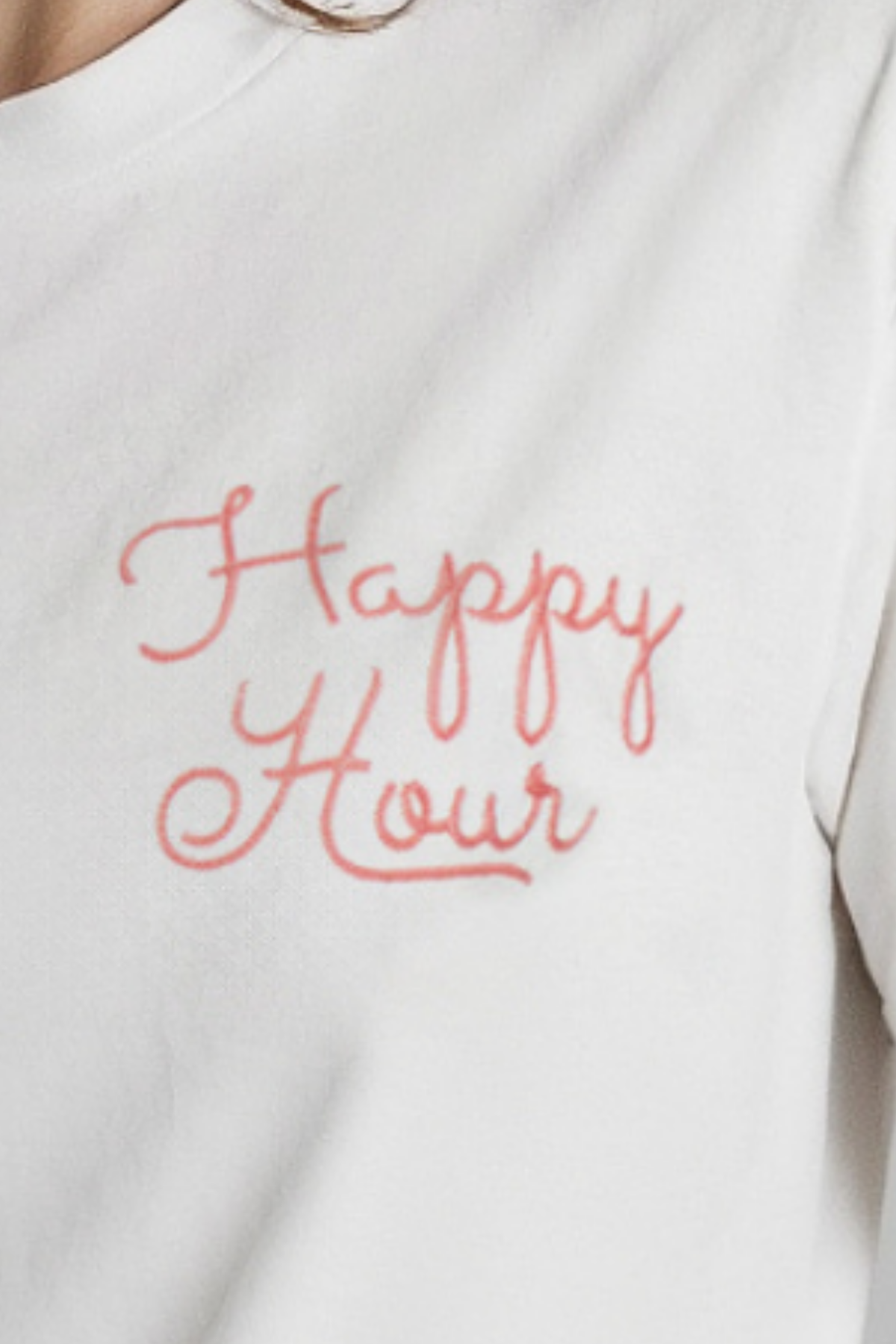 A woman wearing a white crop tee with the text &