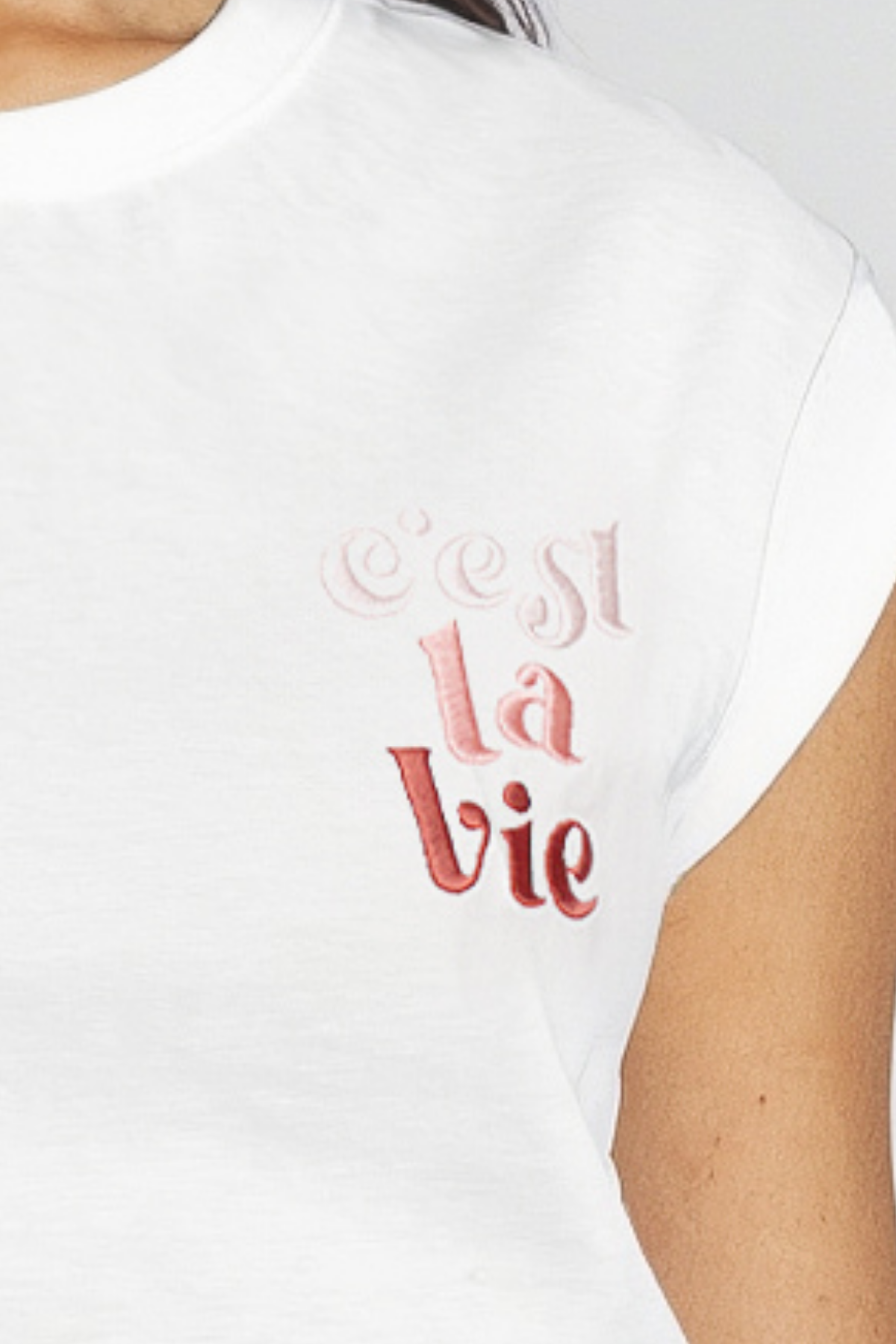 White t-shirt with pink/red text &