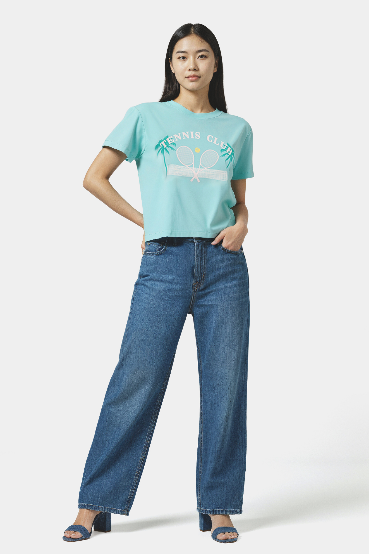 Woman wearing a light teal blue t-shirt with &