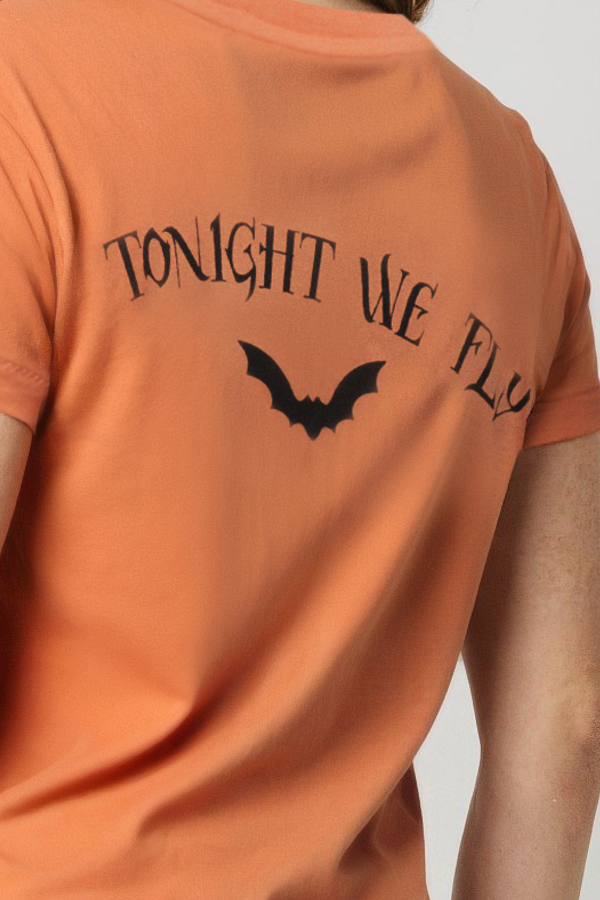 Close up of back orange t-shirt with &
