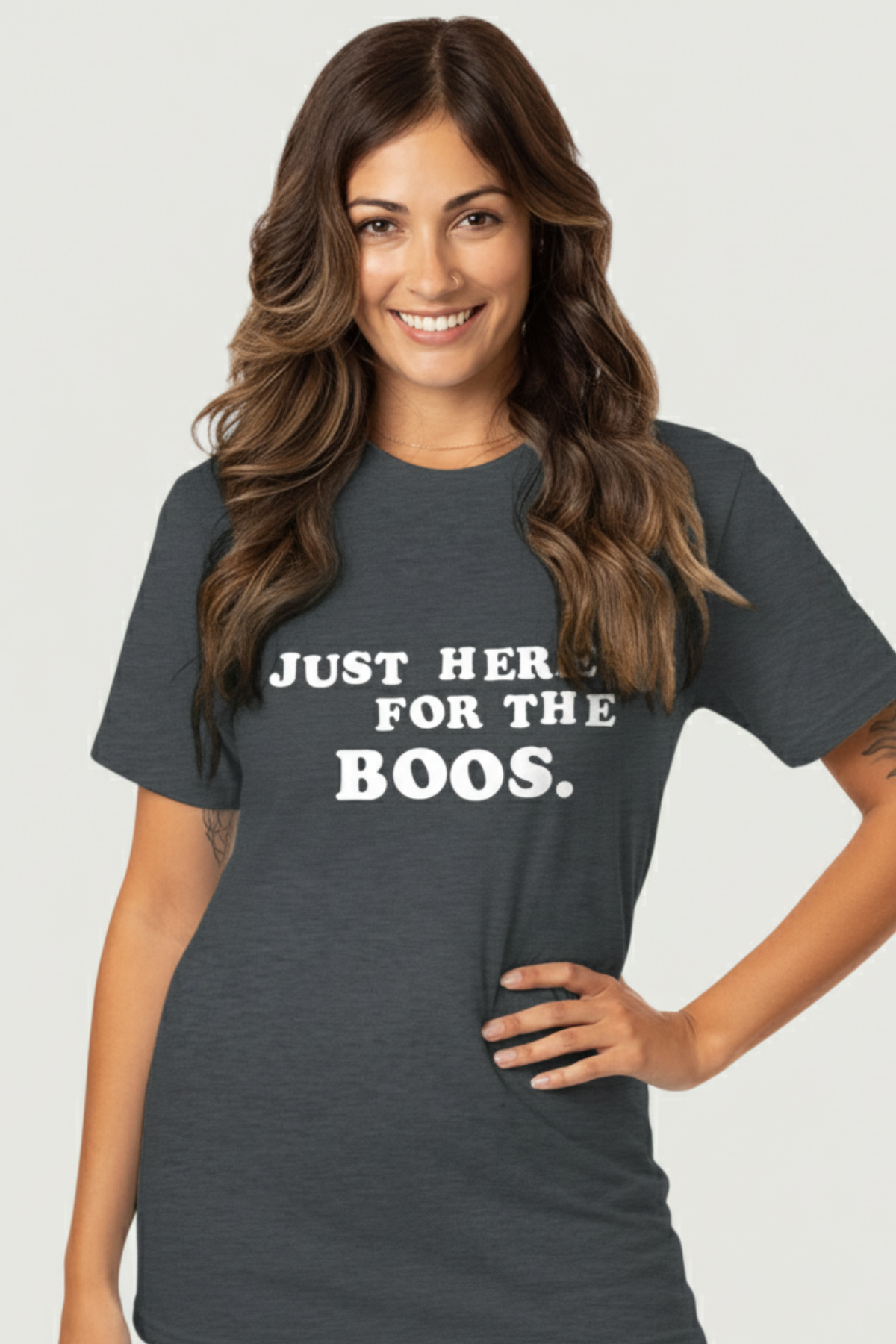 A woman wearing a gray crew neck t-shirt with the white text &