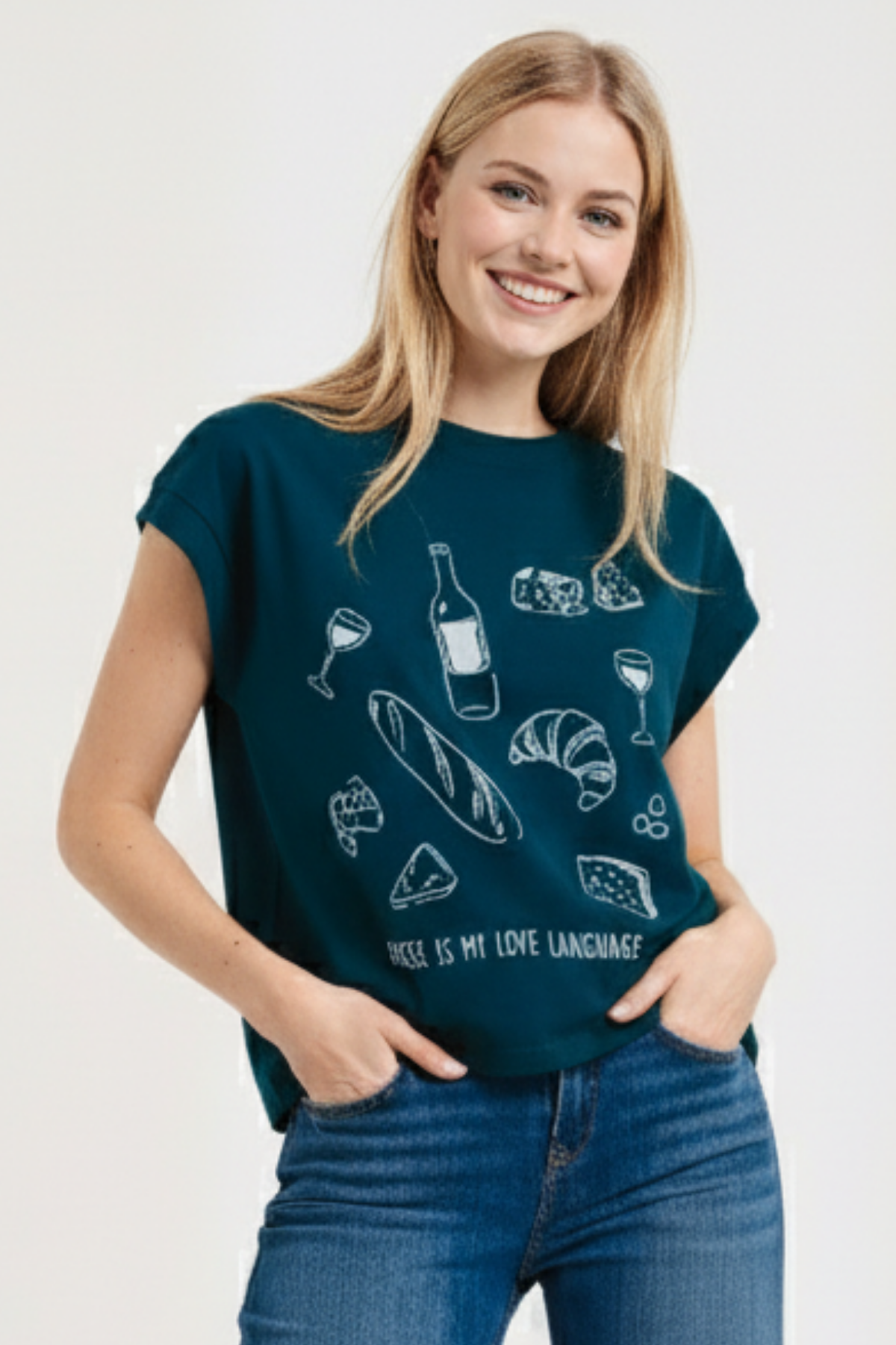 Woman wearing a teal t-shirt with white illustrations of cheese, wine, and bread, and text &