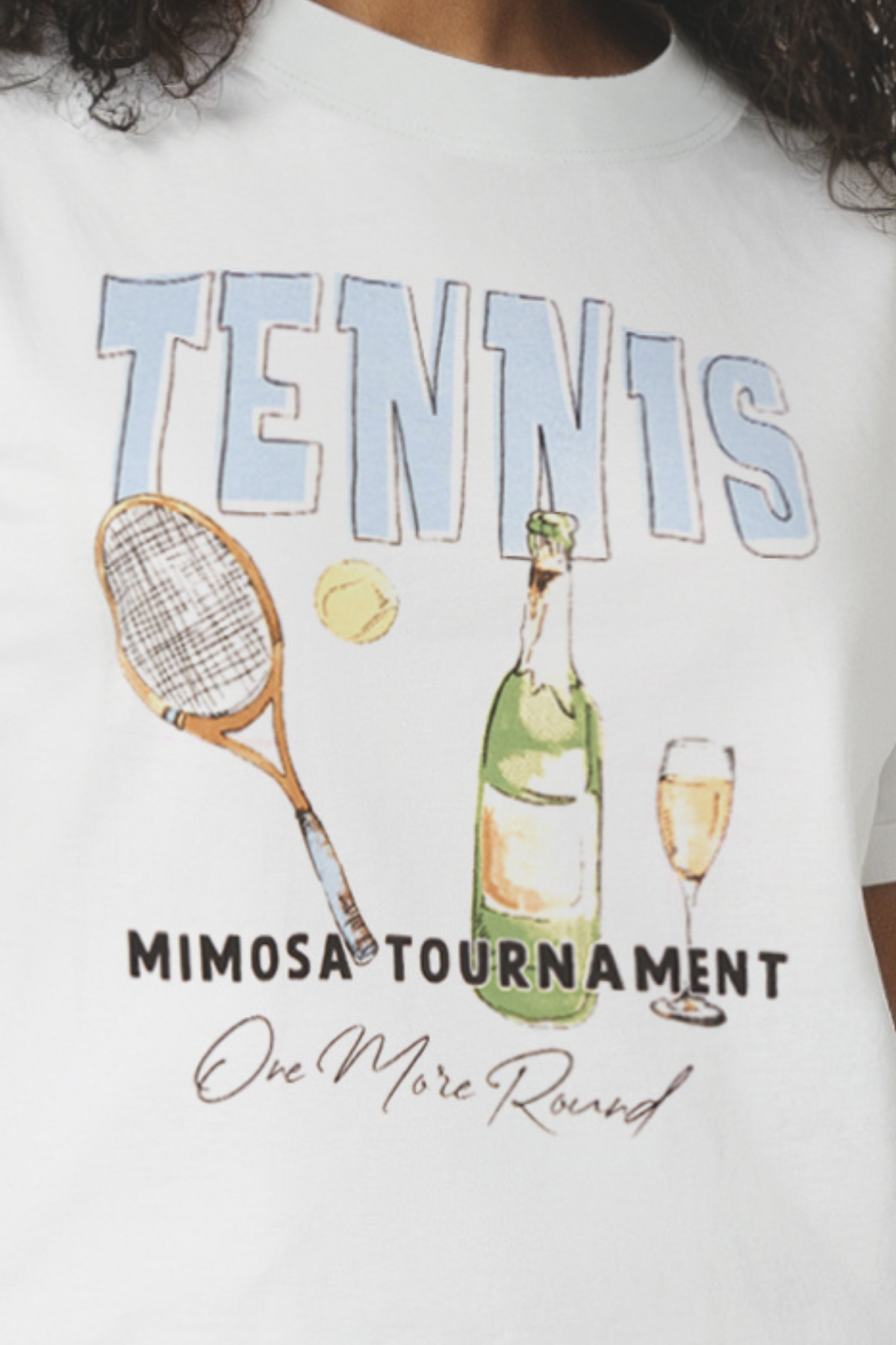 Close up of a woman wearing a light blue t-shirt with &