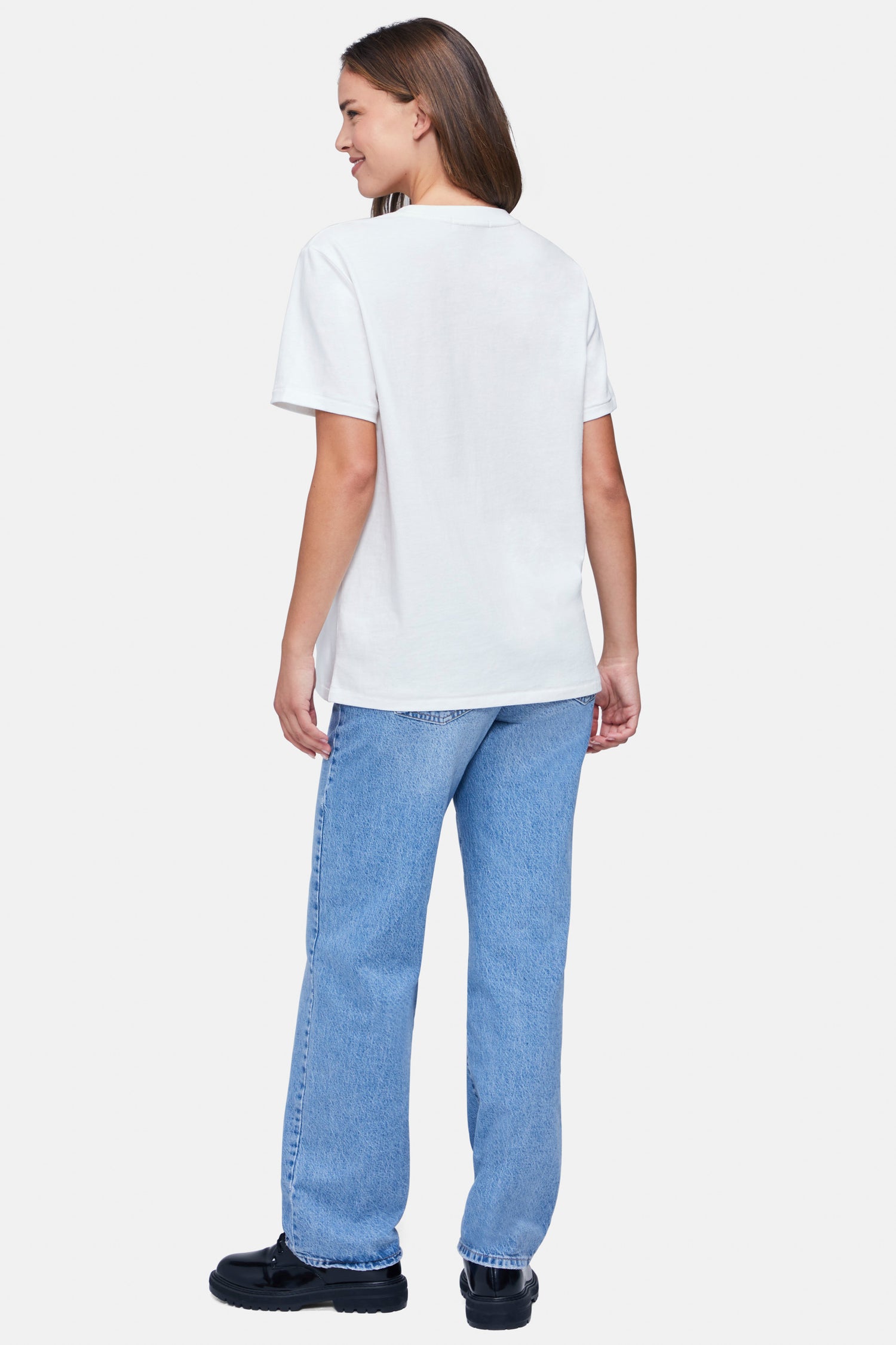 Back of woman wearing a white t-shirt and blue denim jeans on a white background