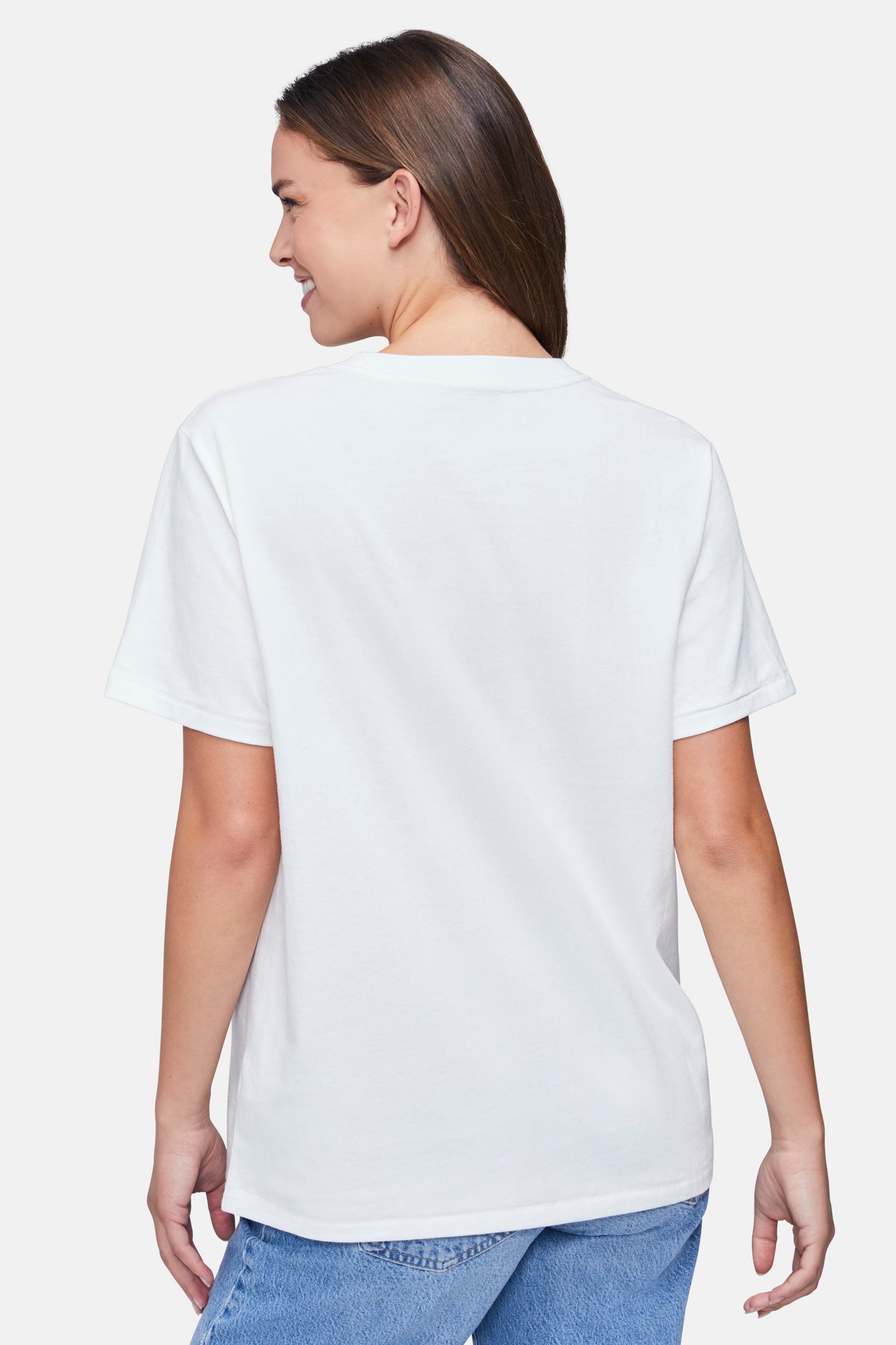 Back of woman wearing a white t-shirt and blue denim jeans on a white background