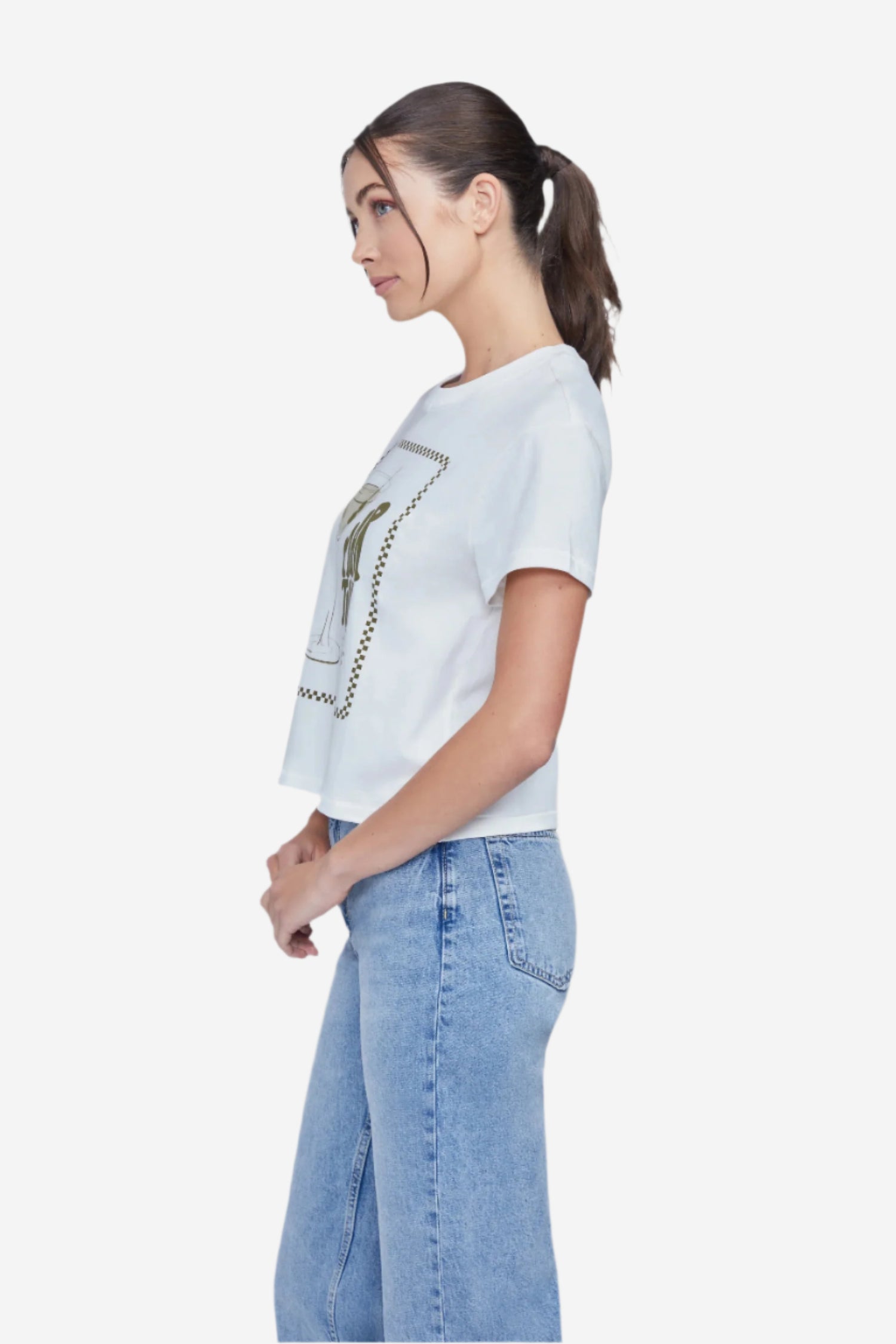 A woman wearing a white crop top with a martini glass graphic and text that includes &