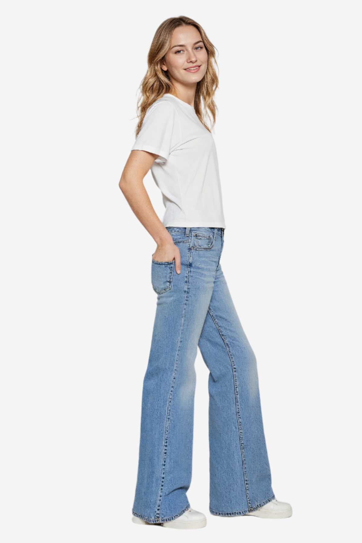 A woman wearing a white crewneck t-shirt with the phrase &