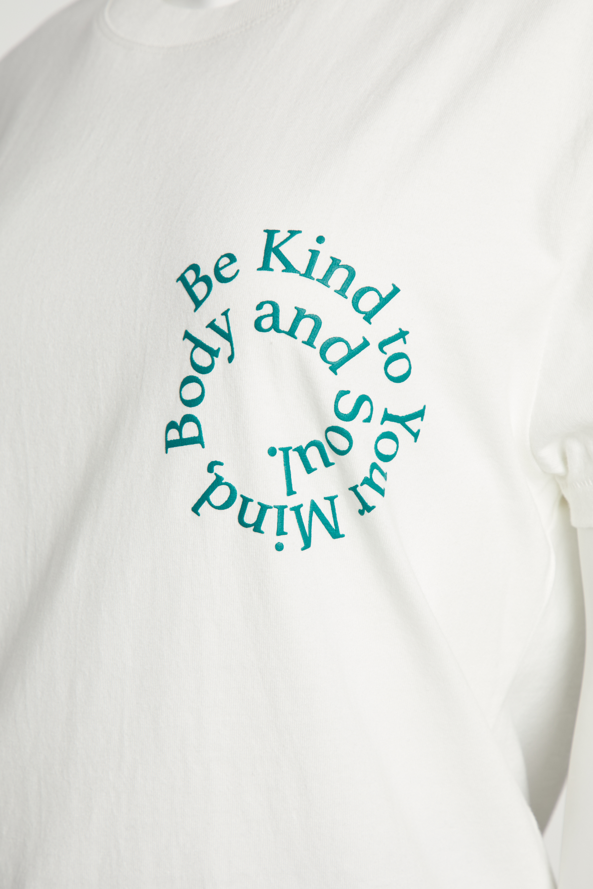 Close up of white crewneck t-shirt with the phrase &