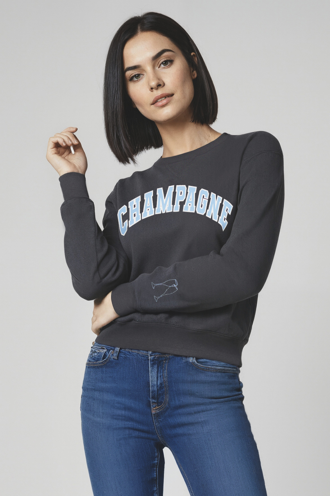 Woman wearing a black sweatshirt with &