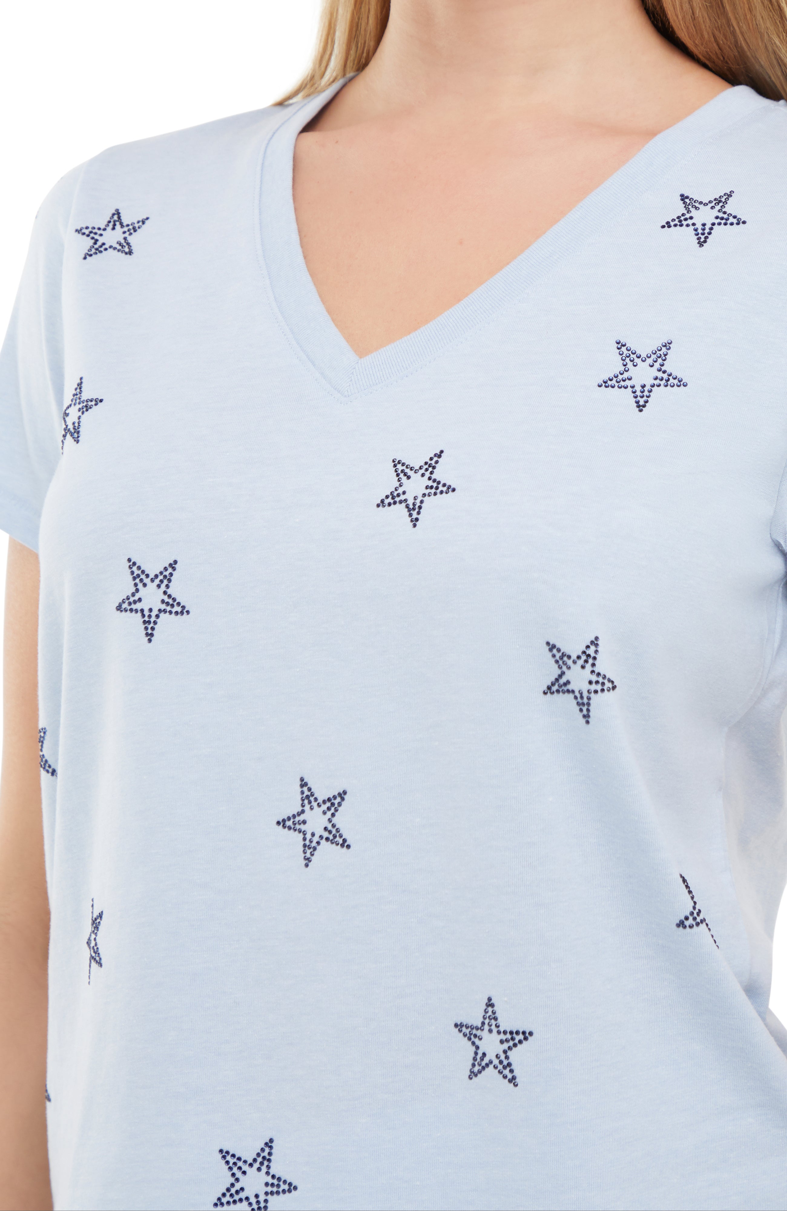 Close up of Light blue sleeveless top with rhinestone star patterns on a white background