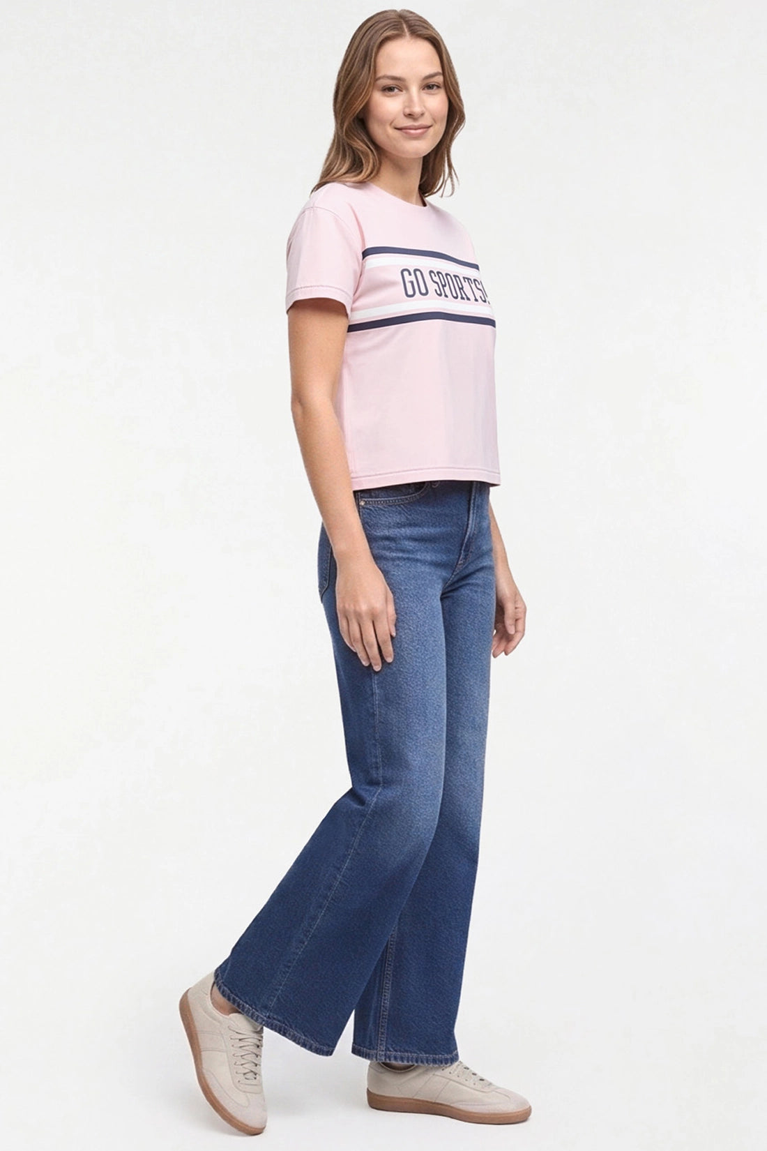 A woman modeling a light pink short-sleeve crop top with a navy blue stripe and &