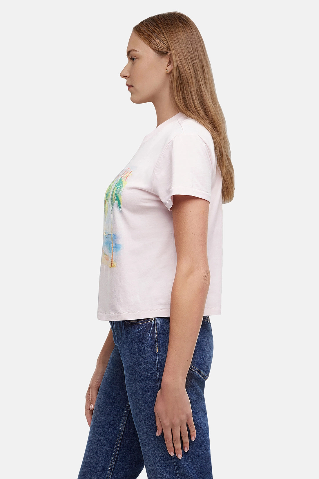 Side view of woman wearing a pink t-shirt with a beach graphic and &