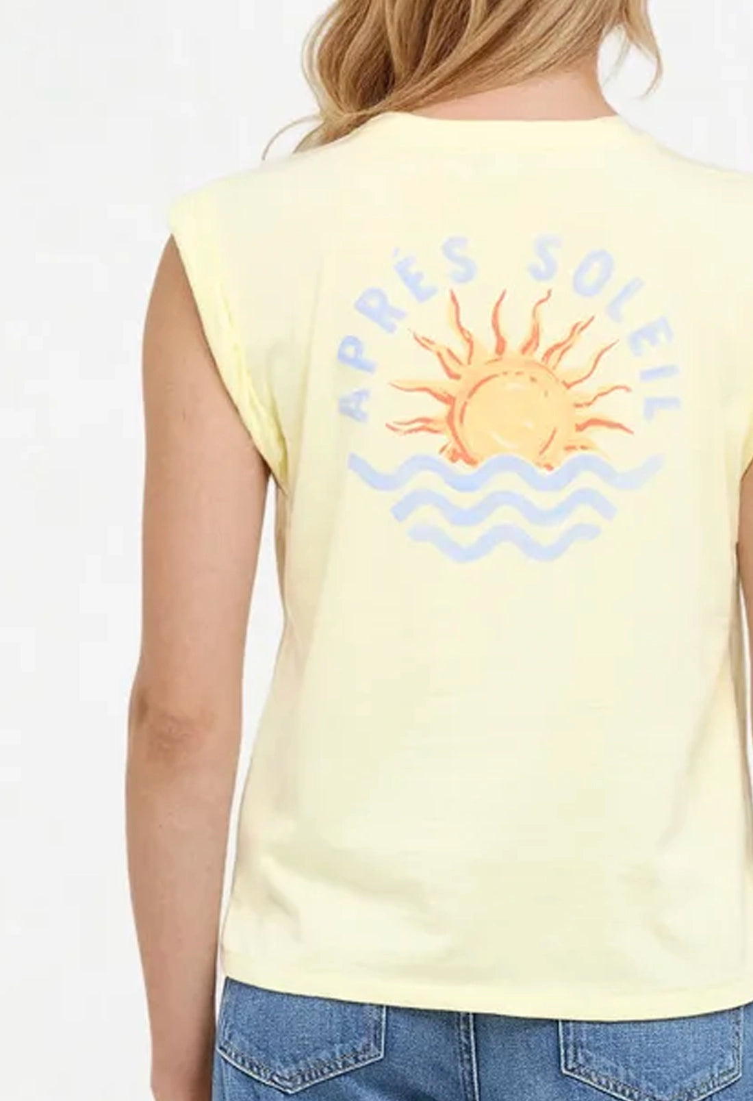 Close up back view of woman wearing a yellow sleeveless shirt with a sun and wave design and &