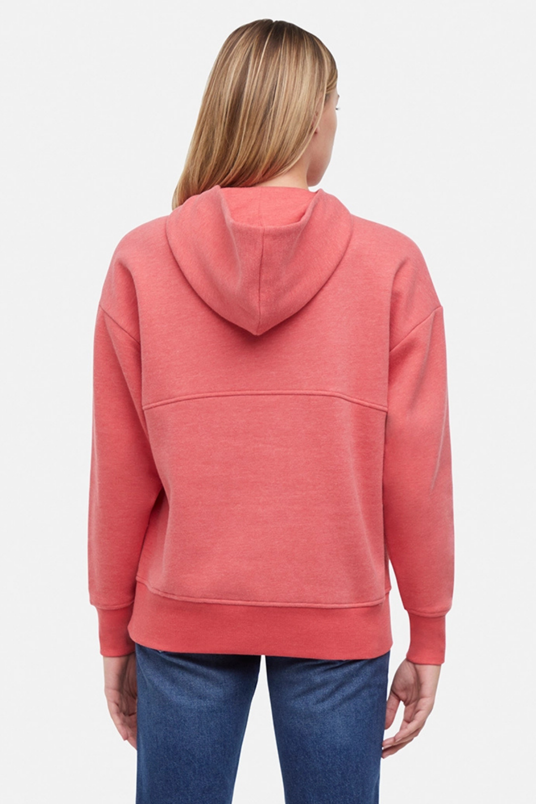 Back of woman wearing a pink/red hoodie and blue jeans on a white background