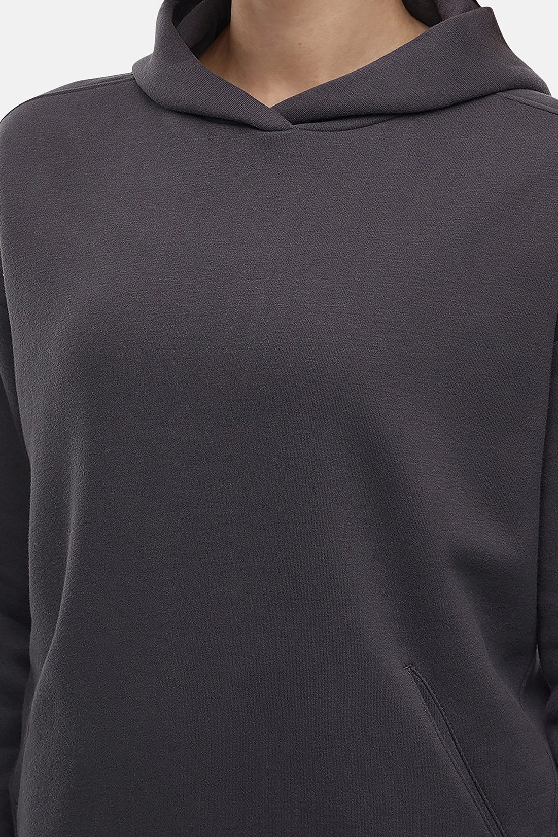 Close-up of woman wearing a dark gray hoodie with a hood