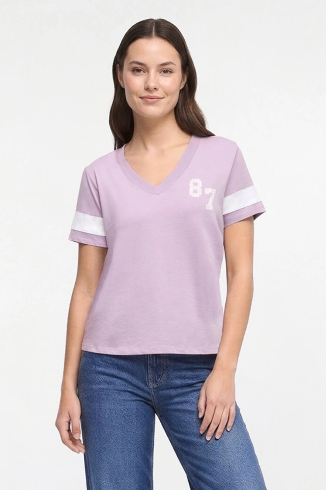 A woman modeling a light purple v-neck t-shirt with white sleeve stripes and a white &