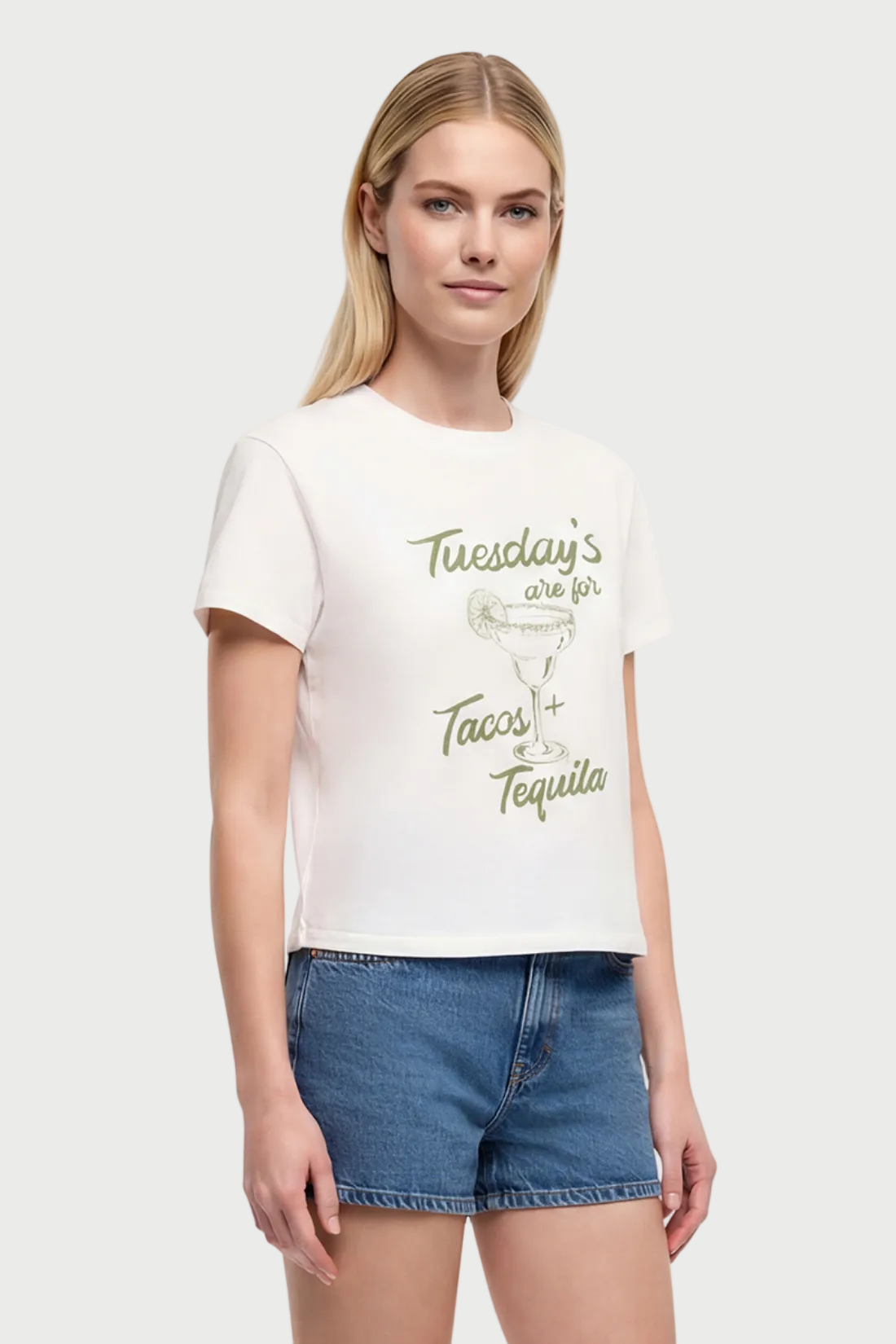 Front view of woman wearing a white t-shirt with a tequila cocktail glass graphic design and "Tuesday&