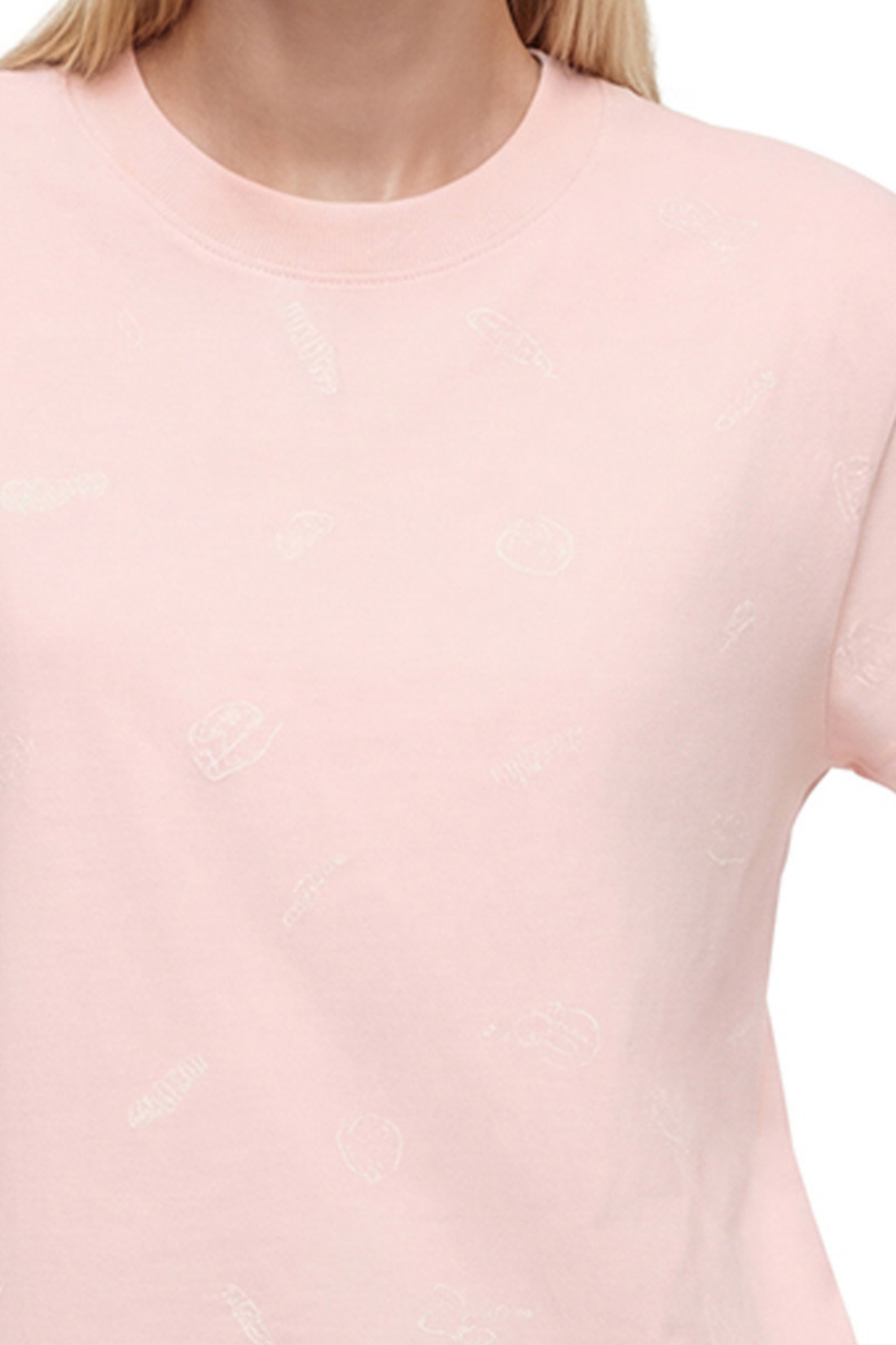 Close up view of woman wearing a light pink t-shirt with pasta noodle shapes pattern design on a white background.