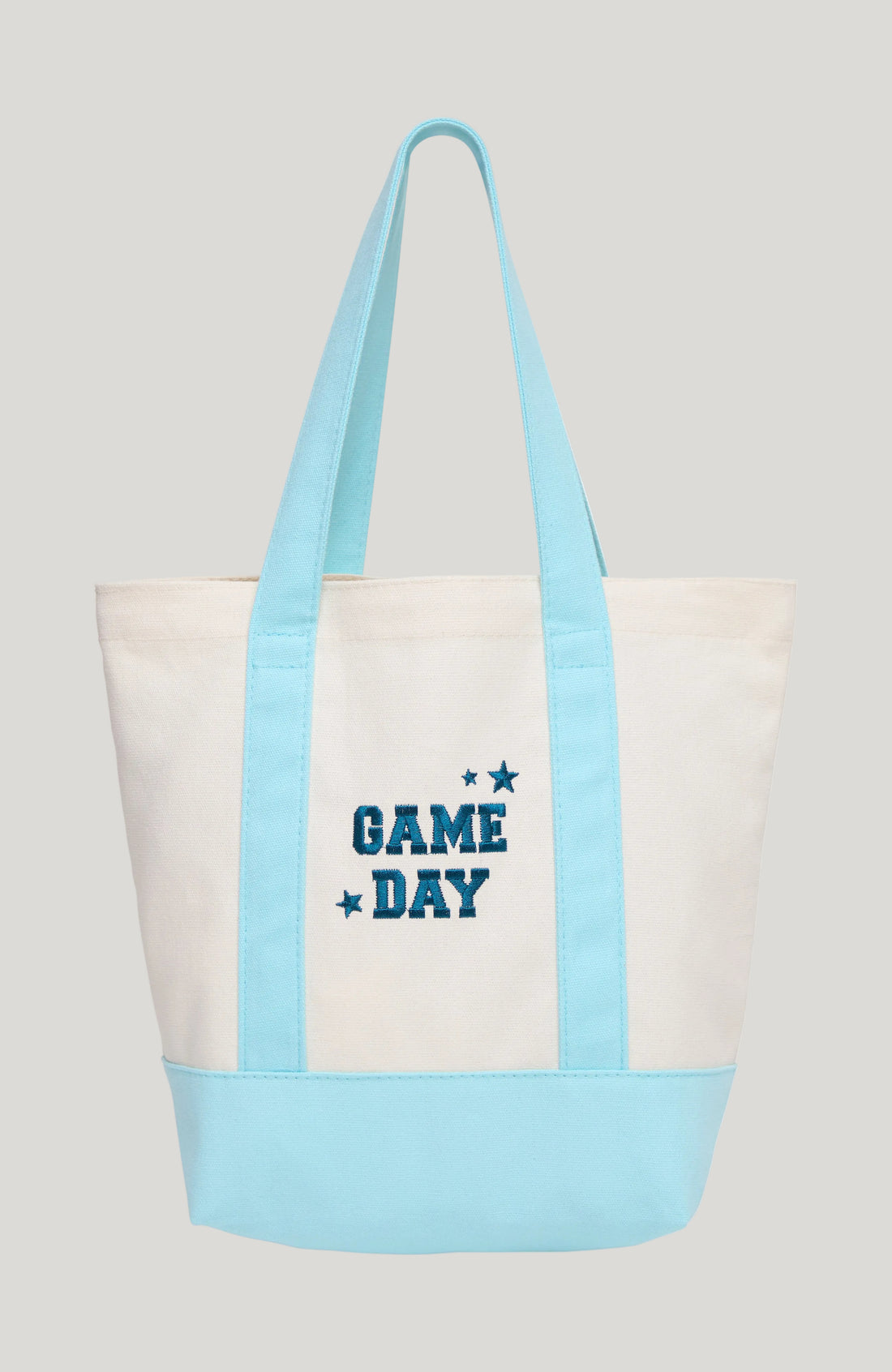 A canvas tote bag with a cream body, light blue handles and bottom panel, and &