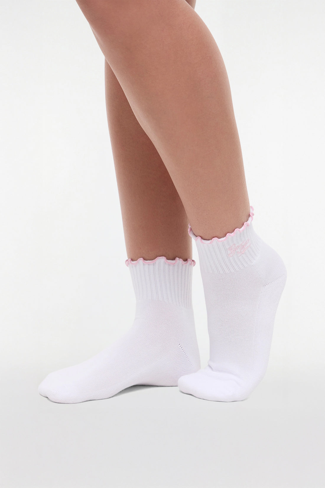 Side view of white socks with lilac ruffled trim and &