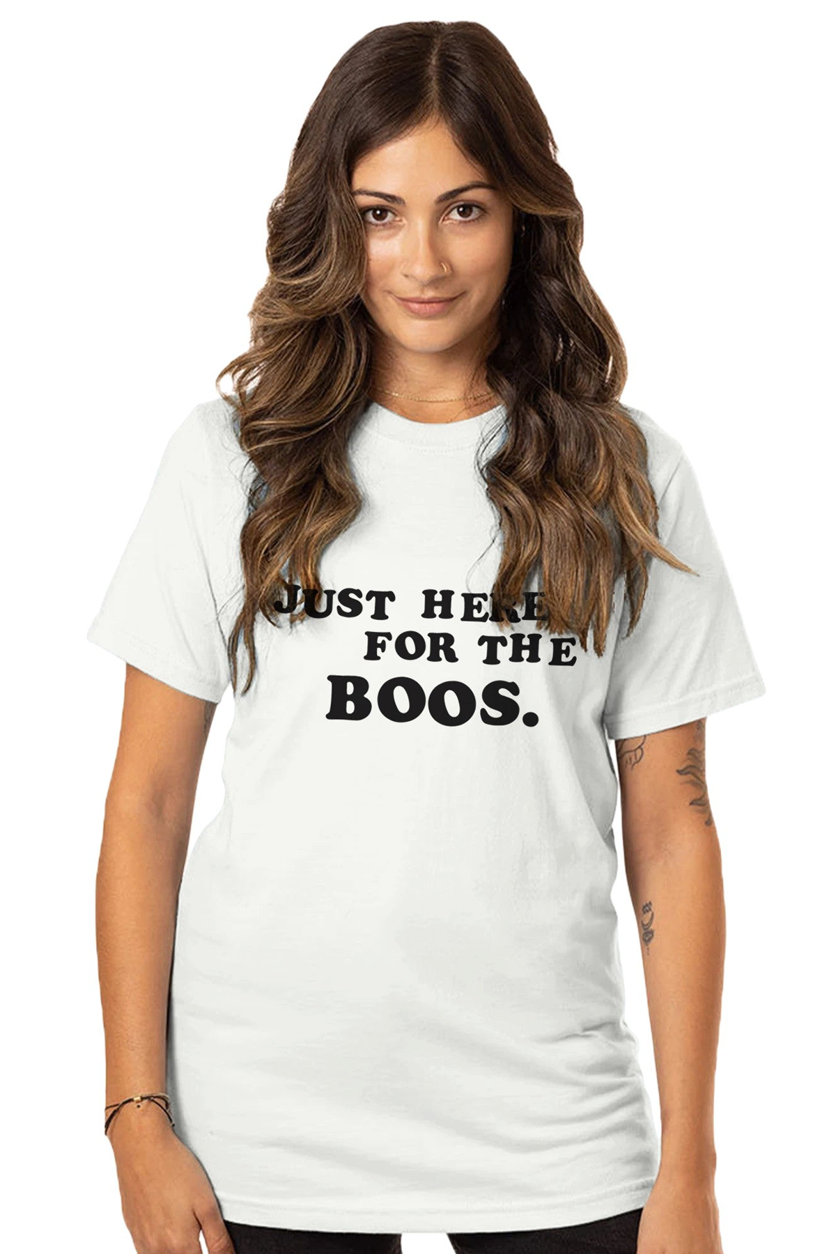 A woman wearing a white crew neck t-shirt with the text &