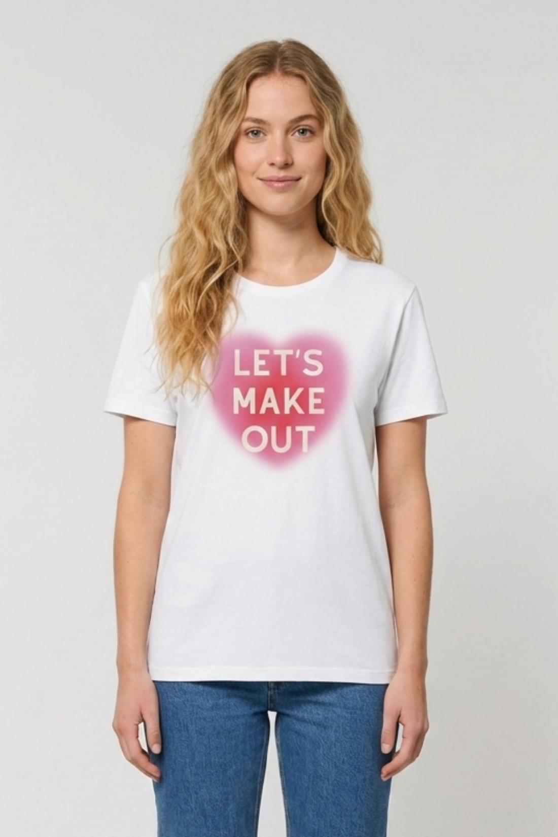 Woman wearing white t-shirt with pink heart and text &