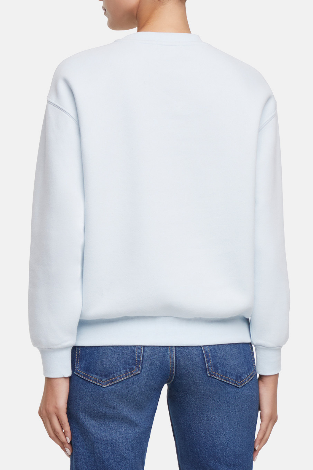Back of Light blue sweatshirt worn by a woman on a white background