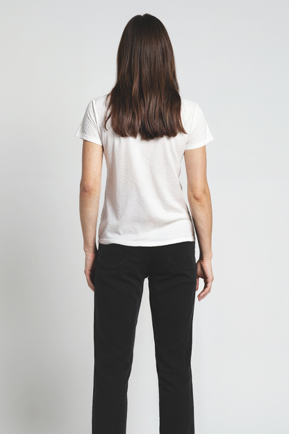Woman wearing a white t-shirt and black pants on a plain background