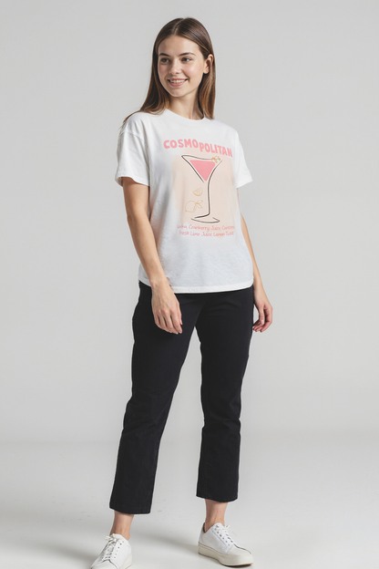Woman wearing a white t-shirt with a graphic design on a plain background