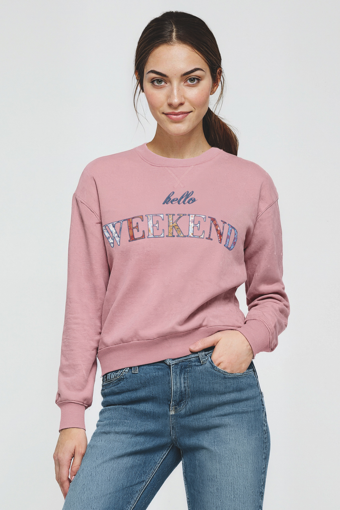 Woman wearing a pink sweatshirt with &