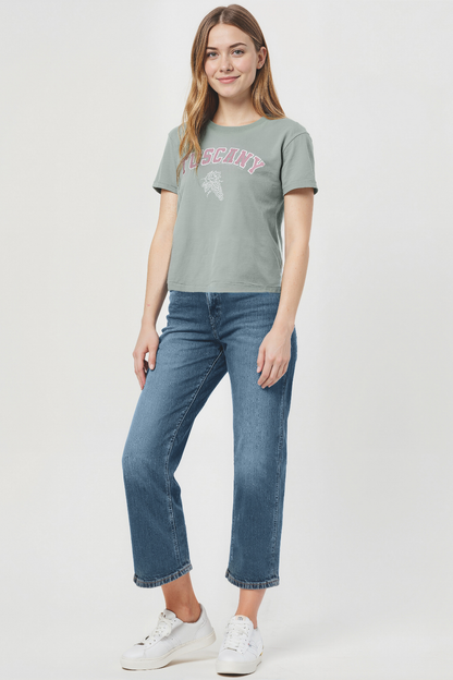 Woman wearing a green t-shirt with &