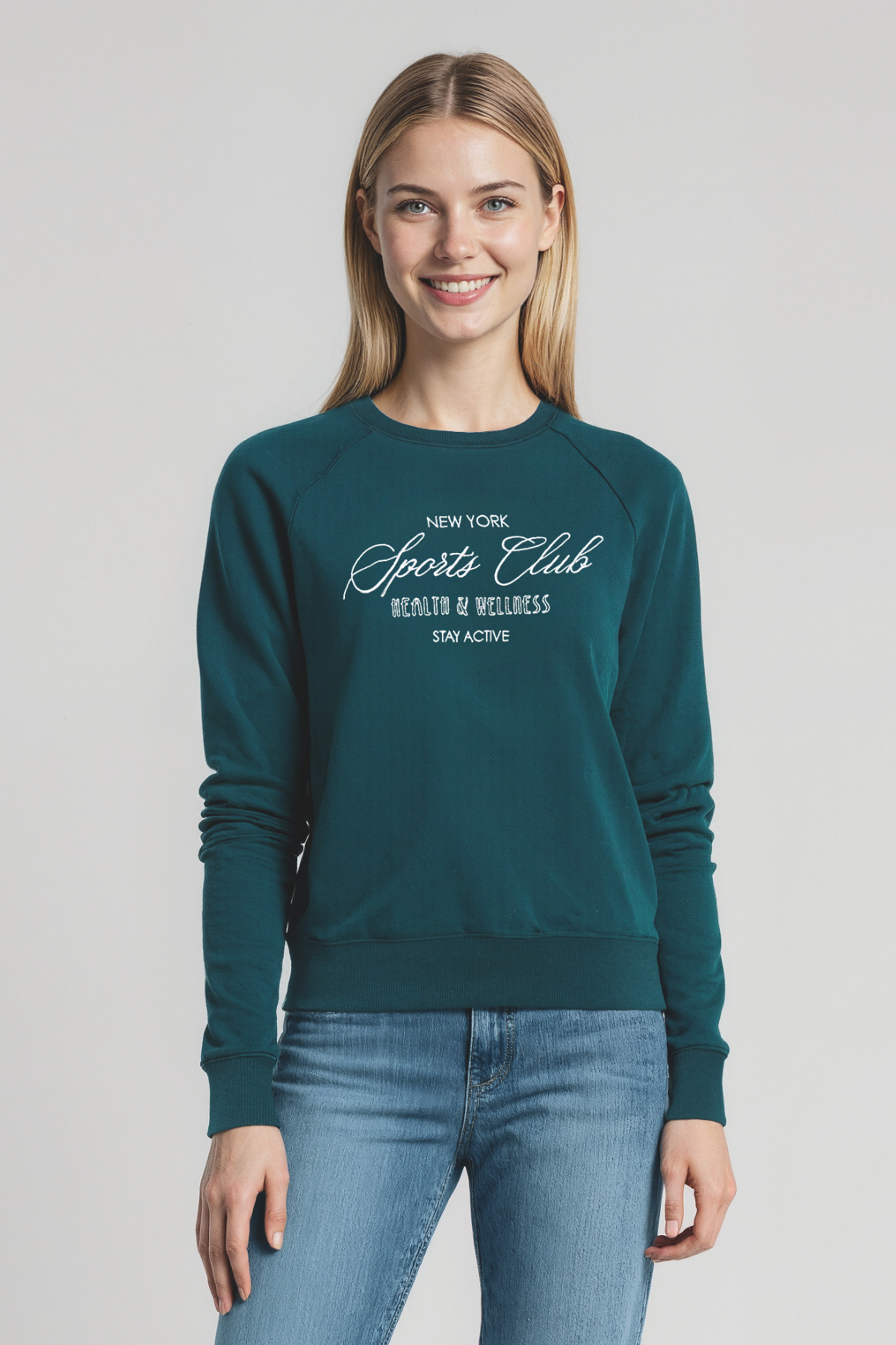 Woman wearing a teal sweatshirt with &quot;New York Sports Club, HEALTH and WELLNESS&