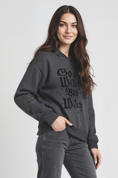 Woman wearing a dark gray hoodie with text on a plain background