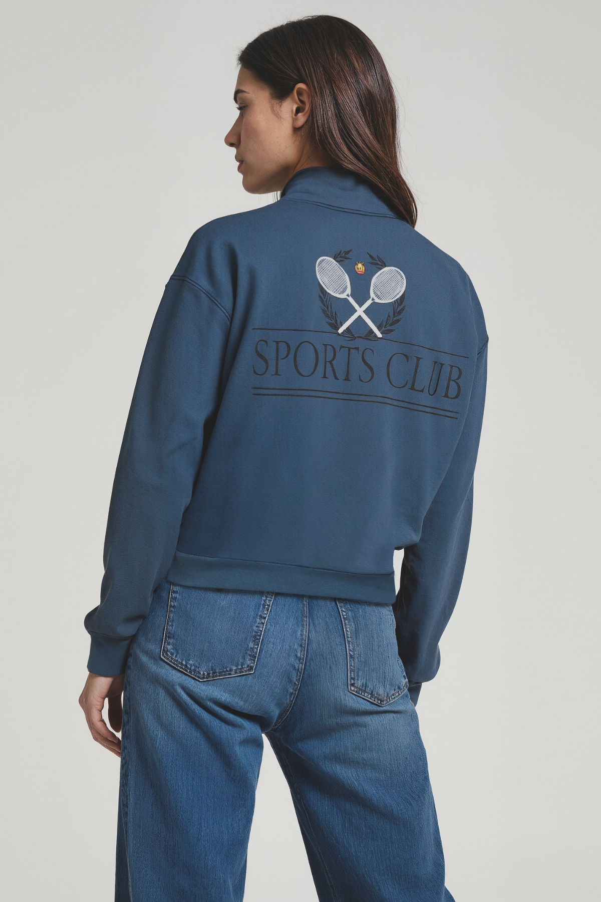 Woman wearing a blue sweatshirt with &