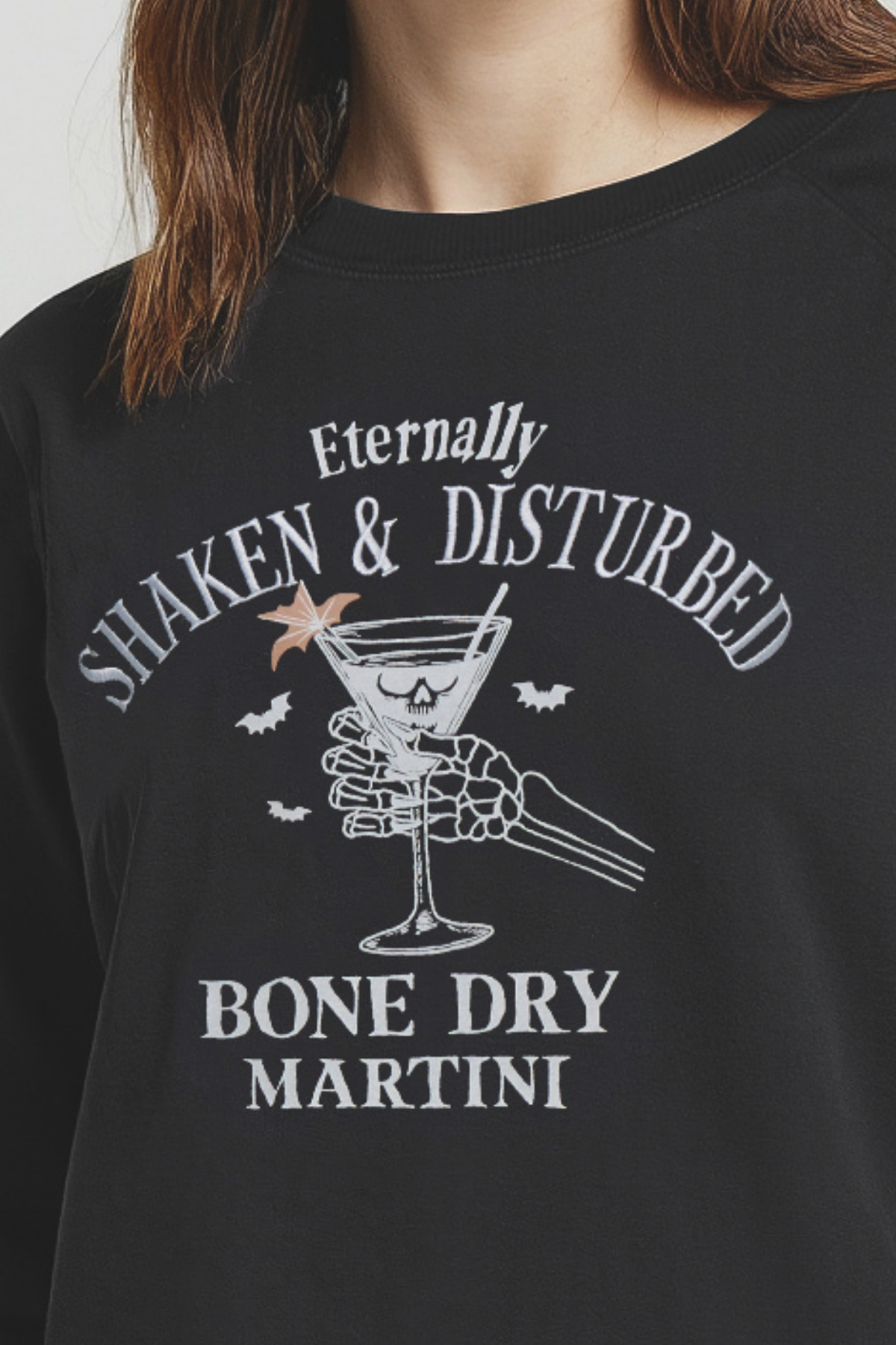 Black t-shirt with white graphic design of a skeleton holding a martini glass and text &