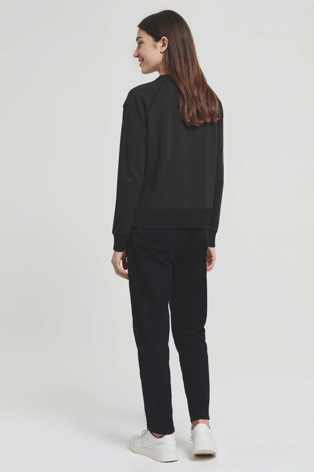 Person wearing a black outfit on a white background