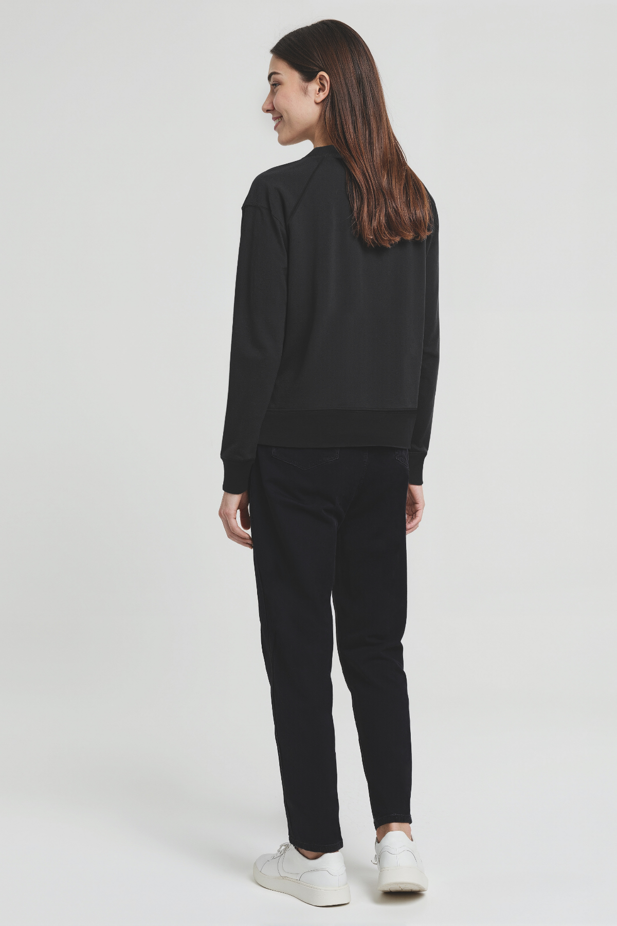 Person wearing a black outfit on a white background