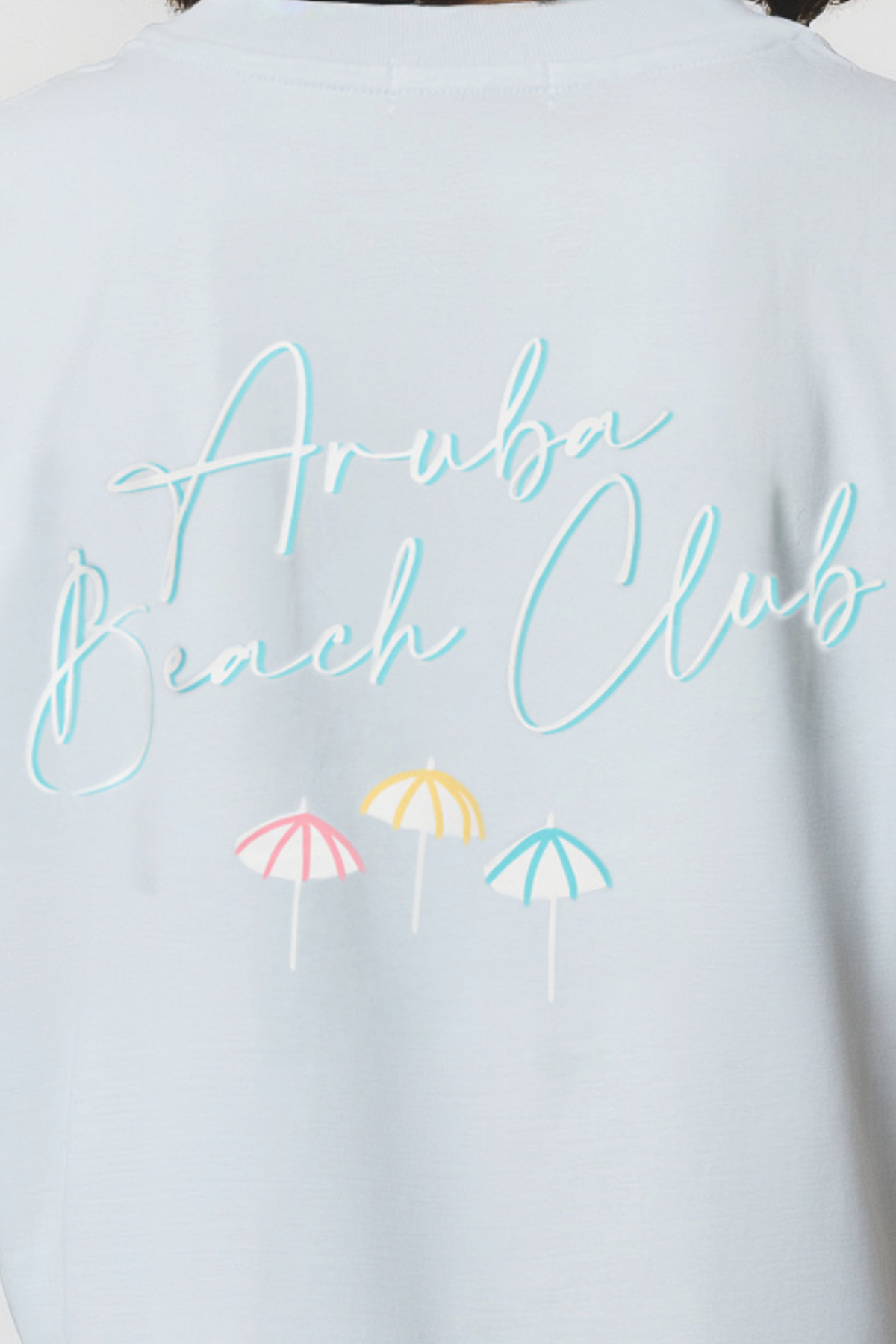 Close up of ight blue shirt with &