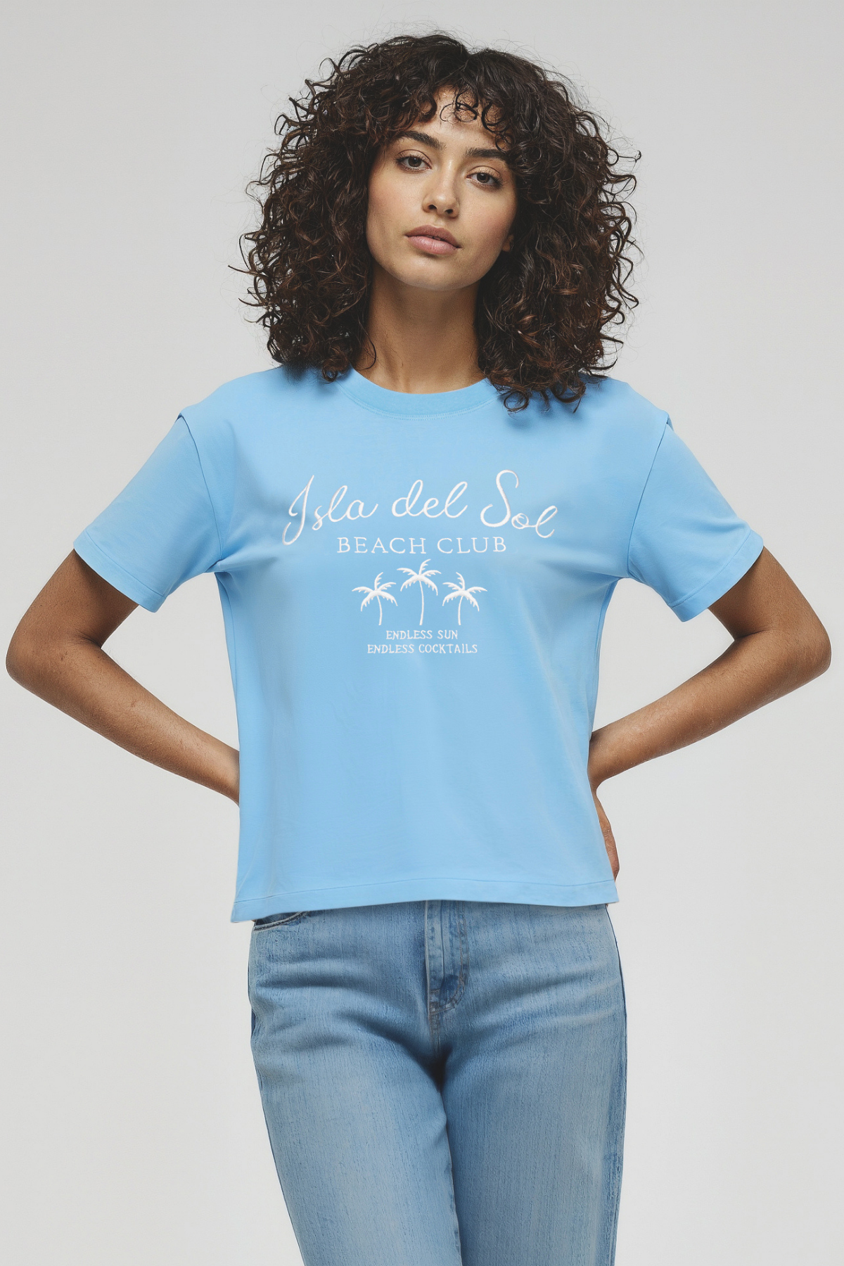 Woman wearing a light blue t-shirt with &