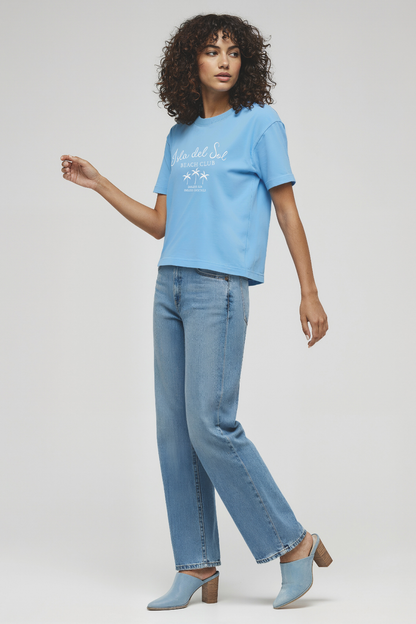 Woman wearing a light blue t-shirt with &