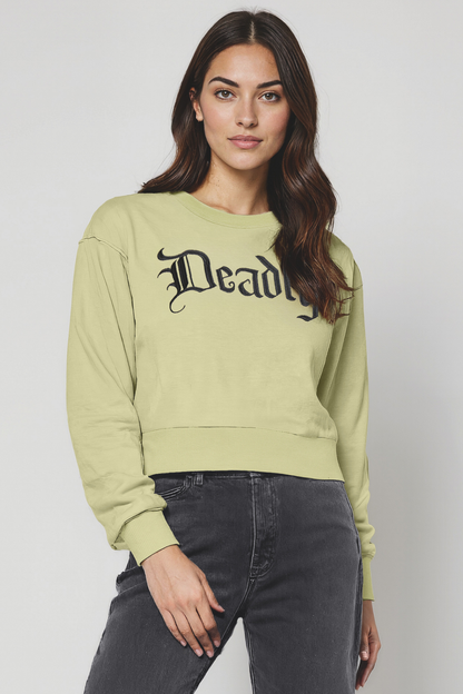 Woman wearing a light green sweatshirt with &