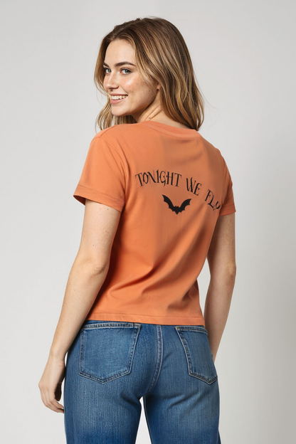 Woman wearing an orange t-shirt with &