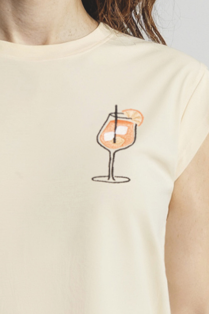 Close up of yellow front tank with a cocktail graphic worn by a woman