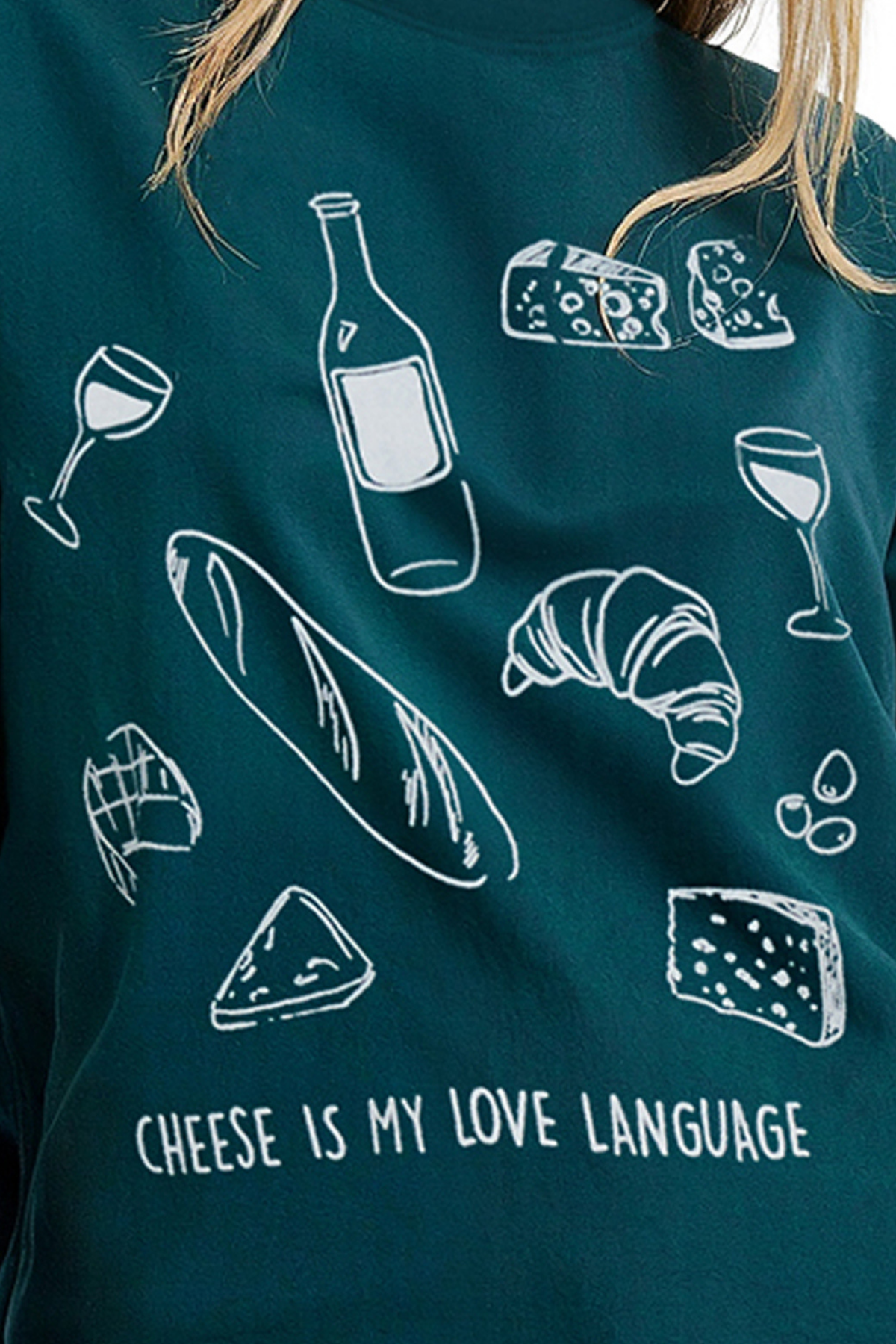 Close up of front of teal t-shirt with white illustrations of cheese, wine, and bread, and text &