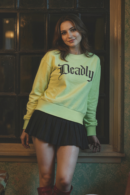 Woman wearing a light green sweater with &