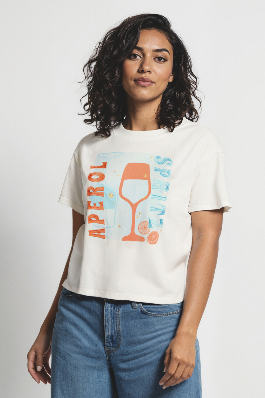 Woman wearing white t-shirt with a colorful graphic of a wine glass and &