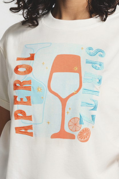 Close up of white t-shirt with a colorful graphic of a wine glass and &